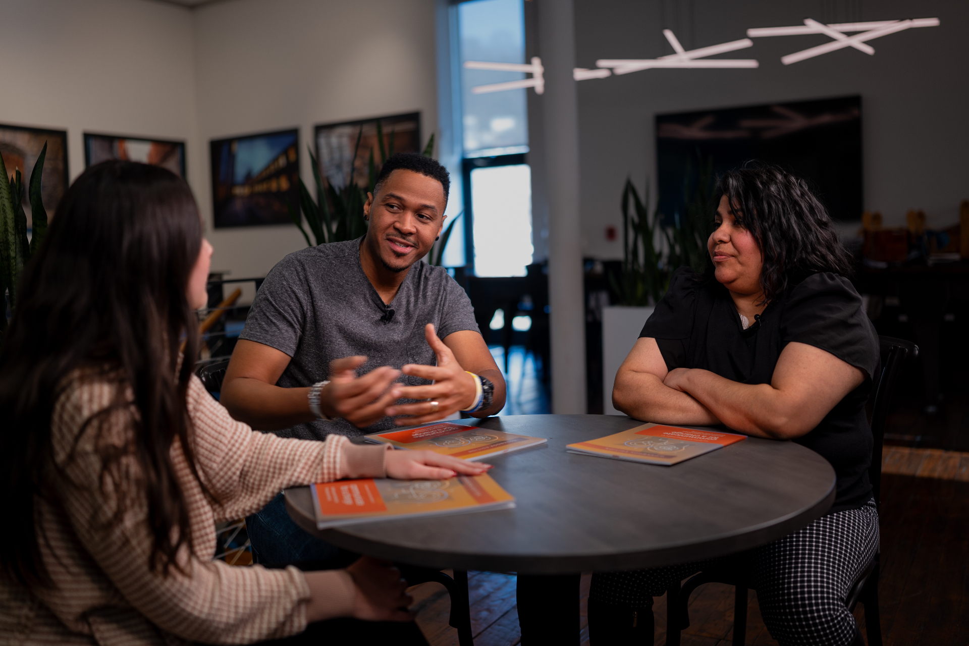 Three people listening and sharing together in a triad group